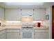 Bright kitchen features white cabinets, white countertops, and white oven/range at 440 Pendleton Dr, Venice, FL 34292