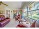 Bright living area boasts a comfortable seating arrangement and views of the lush greenery outside at 440 Pendleton Dr, Venice, FL 34292