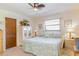 Inviting bedroom featuring a comfortable queen-sized bed, soft lighting, and serene decor at 440 Pendleton Dr, Venice, FL 34292