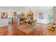 Open dining room with hardwood floors, a light fixture, and stylish decor next to modern kitchen at 4508 Spring Rd, Valrico, FL 33596