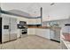 Well-lit kitchen featuring stainless steel appliances, white cabinets, and tiled floors at 4962 112Th N St, St Petersburg, FL 33708