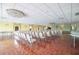 Large auditorium with rows of chairs, chandeliers, parquet flooring, and a stage with a piano at 5220 Brittany S Dr # 1403, St Petersburg, FL 33715
