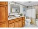 Bathroom with stone countertop vanity, updated fixtures, and shower with curtain at 5220 Brittany S Dr # 1403, St Petersburg, FL 33715
