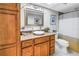 Bathroom with stone countertop vanity, updated fixtures, and shower with curtain at 5220 Brittany S Dr # 1403, St Petersburg, FL 33715