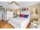Cozy bedroom with nautical theme, white furnishings, and gleaming wood floors at 5220 Brittany S Dr # 1403, St Petersburg, FL 33715