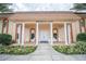 Front exterior of residents clubhouse with flowers and white columns at 5220 Brittany S Dr # 1403, St Petersburg, FL 33715