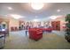 Spacious common area with a variety of seating options, natural light, and a vintage popcorn machine at 5220 Brittany S Dr # 1403, St Petersburg, FL 33715