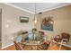 Cozy dining room featuring neutral walls, a glass table, and modern light fixture at 5220 Brittany S Dr # 1403, St Petersburg, FL 33715