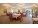 Elegant dining room with multiple tables set with white tablecloths and decorative chandeliers at 5220 Brittany S Dr # 1403, St Petersburg, FL 33715