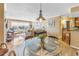 Inviting dining area with glass table, hardwood floors, and access to the bright and airy living room at 5220 Brittany S Dr # 1403, St Petersburg, FL 33715