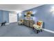 Hallway with blue carpet, waiting chairs, and small accent table at 5220 Brittany S Dr # 1403, St Petersburg, FL 33715