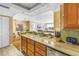 Open kitchen with granite countertops with views of the living room and dining area at 5220 Brittany S Dr # 1403, St Petersburg, FL 33715