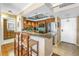 Open concept kitchen with breakfast bar and seating; tile floors lead to the front door at 5220 Brittany S Dr # 1403, St Petersburg, FL 33715