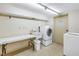Community laundry room with washer, dryer, utility sink, and folding table at 5220 Brittany S Dr # 1403, St Petersburg, FL 33715