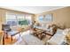 Bright living room with neutral decor, plush rug, and large windows offering city views at 5220 Brittany S Dr # 1403, St Petersburg, FL 33715