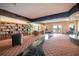 Inviting lounge area with a large bookcase, cozy seating, and a decorative black stone walkway design at 5220 Brittany S Dr # 1403, St Petersburg, FL 33715