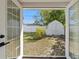 View of the backyard through open french doors, highlighting a well-maintained yard with a charming shed and ample space at 5314 13Th S Ave, Gulfport, FL 33707