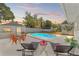 Relaxing backyard featuring a private in-ground pool, lounge chairs, and cozy outdoor seating surrounded by lush greenery at 5314 13Th S Ave, Gulfport, FL 33707