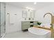 Modern bathroom featuring double sinks, a luxurious soaking tub, and contemporary fixtures for a spa-like retreat at 5314 13Th S Ave, Gulfport, FL 33707