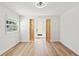 Bedroom featuring wood-look floors, white shiplap walls, and rustic barn door at 5314 13Th S Ave, Gulfport, FL 33707