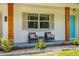 Cozy front porch with seating area, perfect for enjoying the outdoors at 5314 13Th S Ave, Gulfport, FL 33707