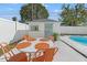 Backyard pool area featuring a dining table, outdoor kitchen and tropical landscaping at 5314 13Th S Ave, Gulfport, FL 33707