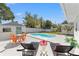 Relaxing backyard featuring a private pool, lounge chairs, and an outdoor seating area at 5314 13Th S Ave, Gulfport, FL 33707