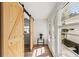 Bright sun room featuring wood floors, barn doors, large windows and white shiplap walls at 5314 13Th S Ave, Gulfport, FL 33707