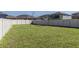 Large grassy backyard enclosed by a tall white fence, offering privacy and space at 5412 Olano St, Palmetto, FL 34221