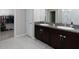 Bathroom featuring a double sink vanity with granite countertop and a walk-in closet at 5412 Olano St, Palmetto, FL 34221