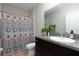Bathroom featuring a single sink vanity with granite countertop, toilet, and a shower with a colorful curtain at 5412 Olano St, Palmetto, FL 34221