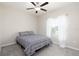 Simple bedroom featuring neutral walls, soft gray carpet, ceiling fan, and a window with sheer white curtains at 5412 Olano St, Palmetto, FL 34221