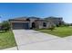 Charming single-Gathering home featuring a two-car garage and a well-manicured front lawn at 5412 Olano St, Palmetto, FL 34221