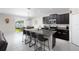 Modern kitchen featuring an island with seating and a stainless steel sink at 5412 Olano St, Palmetto, FL 34221