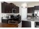 Stylish kitchen with dark cabinets, granite countertops and stainless steel appliances at 5412 Olano St, Palmetto, FL 34221