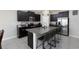 Kitchen boasts an island with seating, dark cabinets and granite countertops at 5412 Olano St, Palmetto, FL 34221