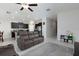 Open-concept living room adjacent to the kitchen featuring tile floors and modern furniture at 5412 Olano St, Palmetto, FL 34221