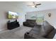 Bright living room with a ceiling fan, large window, and comfortable leather seating at 5412 Olano St, Palmetto, FL 34221
