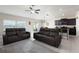Open-concept living area with leather recliners, tile flooring, and an adjacent kitchen at 5412 Olano St, Palmetto, FL 34221