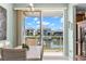 Bright dining area with a view of the water, featuring a white table and chairs, adjacent to the kitchen at 545 Bahia Beach Blvd, Ruskin, FL 33570