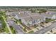 Community aerial view of townhomes and street parking with lush trees at 5728 Skytop Dr, Lithia, FL 33547