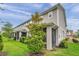 Townhome back exterior featuring a well-maintained lawn and screened patios at 5728 Skytop Dr, Lithia, FL 33547