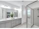 Bathroom featuring double vanity, shower, lots of counter space, and neutral tones at 5728 Skytop Dr, Lithia, FL 33547