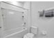 Pristine bathroom featuring a bathtub with shower, toilet, and towel rack, for a clean and functional space at 5728 Skytop Dr, Lithia, FL 33547