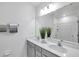 Well-lit bathroom with double vanity, quartz countertop, and large mirror, providing a modern touch at 5728 Skytop Dr, Lithia, FL 33547