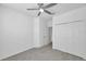 Bright, carpeted bedroom featuring a closet, ceiling fan, and access to connecting rooms at 5728 Skytop Dr, Lithia, FL 33547