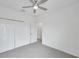 Well-lit bedroom with gray carpet, ceiling fan, and closet, offering a comfortable living space at 5728 Skytop Dr, Lithia, FL 33547