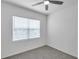 Comfortable bedroom with window and ceiling fan, providing plenty of natural light at 5728 Skytop Dr, Lithia, FL 33547
