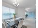 Inviting dining room featuring a dark wood table with seating for four and large windows with blinds at 5728 Skytop Dr, Lithia, FL 33547