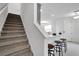 View of the entryway with stairs, counter with stools, and white color scheme at 5728 Skytop Dr, Lithia, FL 33547